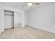A bedroom with carpet, a ceiling fan, and mirrored closet doors with a built in closet system at 553 Sinfold Park St, Las Vegas, NV 89148