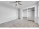 Bedroom featuring neutral carpet, closet with sliding mirror doors and a ceiling fan at 553 Sinfold Park St, Las Vegas, NV 89148