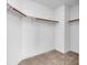 An empty walk-in closet with clothing rods and carpeted floor at 553 Sinfold Park St, Las Vegas, NV 89148