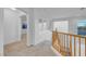 Upstairs hallway with neutral carpet and natural lighting from glass block window at 553 Sinfold Park St, Las Vegas, NV 89148