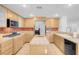 Modern kitchen with oak cabinets, stainless steel appliances, and a kitchen island at 553 Sinfold Park St, Las Vegas, NV 89148