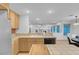 Spacious kitchen features tile countertops, wood cabinets, breakfast bar, and recessed lighting at 553 Sinfold Park St, Las Vegas, NV 89148
