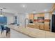 Kitchen with light wood cabinets, tile countertops and stainless steel appliances at 553 Sinfold Park St, Las Vegas, NV 89148