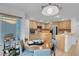 Well-lit kitchen with stainless steel appliances, tile countertops, and an adjacent dining area at 553 Sinfold Park St, Las Vegas, NV 89148