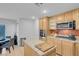 Kitchen with oak cabinets, stainless steel appliances and red tile backsplash at 553 Sinfold Park St, Las Vegas, NV 89148