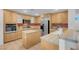 Traditional kitchen features light wood cabinets, island, and stainless appliances at 553 Sinfold Park St, Las Vegas, NV 89148