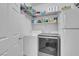 Laundry room with washer, dryer, shelving, and additional storage space at 553 Sinfold Park St, Las Vegas, NV 89148