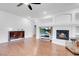 Open living area with a fireplace, television, and dark wood floors at 553 Sinfold Park St, Las Vegas, NV 89148