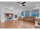 Cozy living room showcasing built-in shelving, fireplace, and ceiling fan at 553 Sinfold Park St, Las Vegas, NV 89148