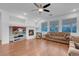 Cozy living room features fireplace, ceiling fan, and wood-look flooring at 553 Sinfold Park St, Las Vegas, NV 89148