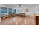 Spacious living room with wood-look flooring, sofas, and large windows at 553 Sinfold Park St, Las Vegas, NV 89148