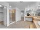 Elegant main bathroom with a glass-enclosed shower, double vanities, and access to walk-in closets at 553 Sinfold Park St, Las Vegas, NV 89148