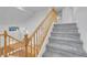 Carpeted staircase with wood railing, offering an upstairs view at 553 Sinfold Park St, Las Vegas, NV 89148