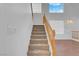 Light-filled staircase with wood railing and carpeted steps at 553 Sinfold Park St, Las Vegas, NV 89148