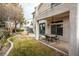 Well-maintained backyard with patio, seating, and grassy area at 575 Dusty Palms Ln, Henderson, NV 89052