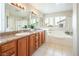 Bathroom with granite countertops, double sinks, and a soaking tub at 575 Dusty Palms Ln, Henderson, NV 89052