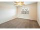 Simple bedroom featuring ceiling fan, window with blinds, and neutral carpet at 575 Dusty Palms Ln, Henderson, NV 89052