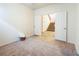 Neutral bedroom with a door opening to the tiled hallway and stairs at 575 Dusty Palms Ln, Henderson, NV 89052