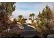 Community entrance with palm trees and houses at 575 Dusty Palms Ln, Henderson, NV 89052