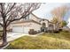 Two-story house with a three-car garage and landscaped lawn at 575 Dusty Palms Ln, Henderson, NV 89052