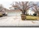 Two-story house with a three-car garage and landscaped front yard at 575 Dusty Palms Ln, Henderson, NV 89052