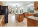 Spacious kitchen with island, wood cabinets, and granite countertops at 575 Dusty Palms Ln, Henderson, NV 89052