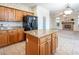 Kitchen with center island, granite countertops, and modern appliances, opens to the living room at 575 Dusty Palms Ln, Henderson, NV 89052