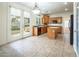 Kitchen with island, wood cabinets, and access to backyard at 575 Dusty Palms Ln, Henderson, NV 89052