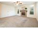 Living room with fireplace and large windows at 575 Dusty Palms Ln, Henderson, NV 89052