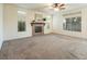 Living room with fireplace and large windows at 575 Dusty Palms Ln, Henderson, NV 89052