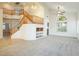 Two-story living room with a staircase and built-in shelving at 575 Dusty Palms Ln, Henderson, NV 89052