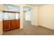 Inviting living room features a wet bar, neutral carpet and views to the next room at 575 Dusty Palms Ln, Henderson, NV 89052