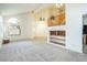 Living room featuring high ceilings, large windows, and access to kitchen at 575 Dusty Palms Ln, Henderson, NV 89052