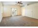 Spacious main bedroom with patio access and ceiling fan at 575 Dusty Palms Ln, Henderson, NV 89052