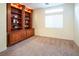 Spacious office with built-in wooden shelving and window at 575 Dusty Palms Ln, Henderson, NV 89052