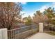 Back patio with metal railing, offering a view of the neighborhood at 575 Dusty Palms Ln, Henderson, NV 89052