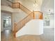 Elegant wooden staircase with a double-height ceiling at 575 Dusty Palms Ln, Henderson, NV 89052