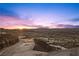 Elevated view of a residential area at sunset, showcasing a luxury home at 577 Overlook Rim Dr, Henderson, NV 89012