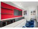 Stylish home bar with wine storage and blue velvet stools at 577 Overlook Rim Dr, Henderson, NV 89012