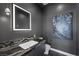 Modern powder room with dark vanity and statement art at 577 Overlook Rim Dr, Henderson, NV 89012