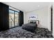 Stylish bedroom with black and white patterned carpet and balcony access at 577 Overlook Rim Dr, Henderson, NV 89012