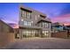 Contemporary home's back exterior showcasing a patio and city views at 577 Overlook Rim Dr, Henderson, NV 89012