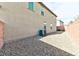 Side yard with gravel landscaping and AC unit at 6046 Castle Gardens Ave, Las Vegas, NV 89130