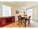 Dining area with wooden table and chairs, sideboard, and access to backyard at 6046 Castle Gardens Ave, Las Vegas, NV 89130