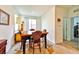 Dining area with wooden table and chairs, sideboard, and access to backyard at 6046 Castle Gardens Ave, Las Vegas, NV 89130