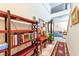 Bright entryway with hardwood floors, shelving, and a view into the living room at 6046 Castle Gardens Ave, Las Vegas, NV 89130