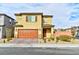 Two-story house with tan exterior, brown garage door, and landscaped front yard at 6046 Castle Gardens Ave, Las Vegas, NV 89130