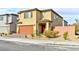 Two-story house with tan exterior, brown garage door, and landscaped front yard at 6046 Castle Gardens Ave, Las Vegas, NV 89130