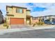 Two-story house with tan exterior, brown garage door, and landscaped front yard at 6046 Castle Gardens Ave, Las Vegas, NV 89130