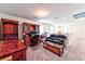 Home office with wooden desk, leather couch, and built-in shelving at 6046 Castle Gardens Ave, Las Vegas, NV 89130